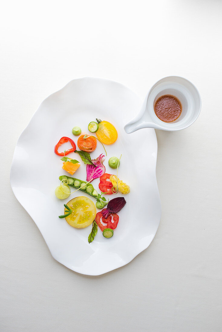 An arrangement of marinated summer vegetables with tomato marinade