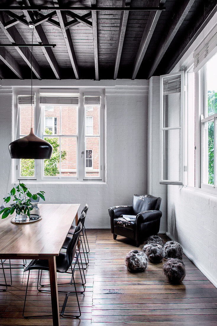 Dining room in old building with floorboards and wooden ceiling