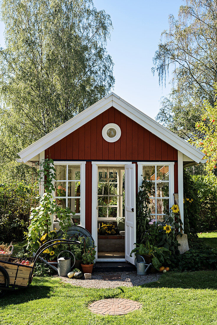 Falu-red, Scandinavian-style summerhouse in summer garden