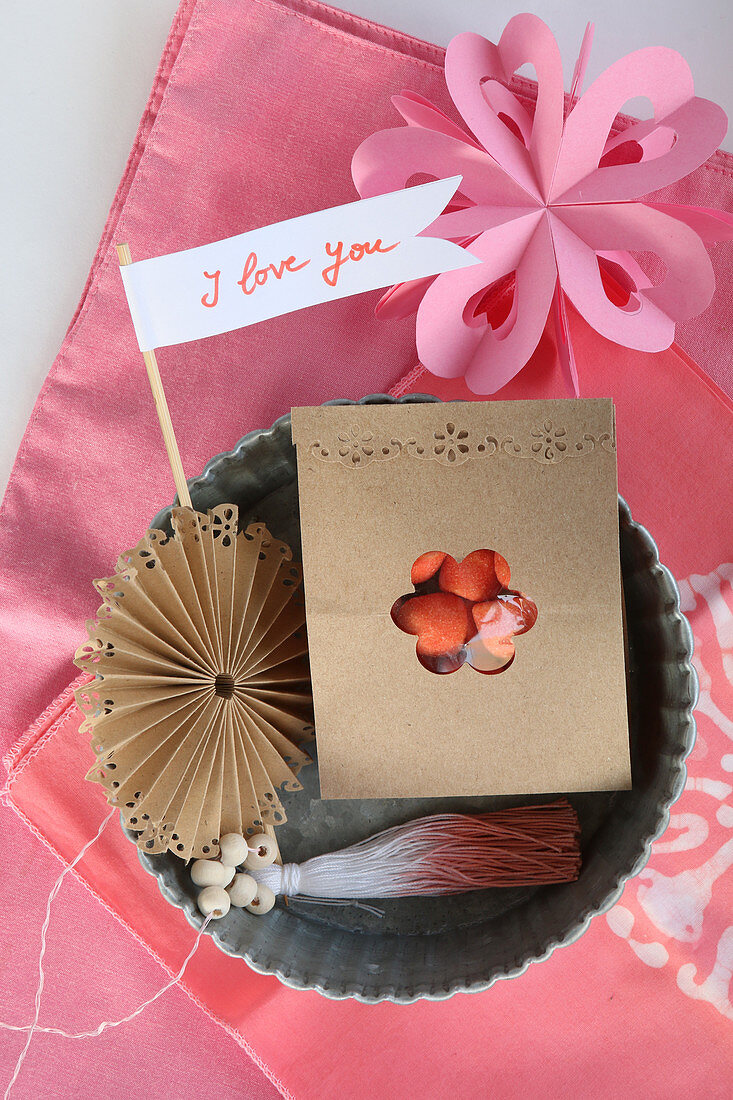 Romantic arrangement in pink with tiny pennant and bag of sweets