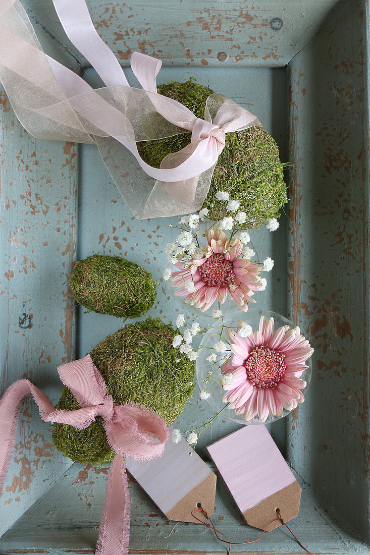 Romantic spring arrangement in muted shades with moss eggs