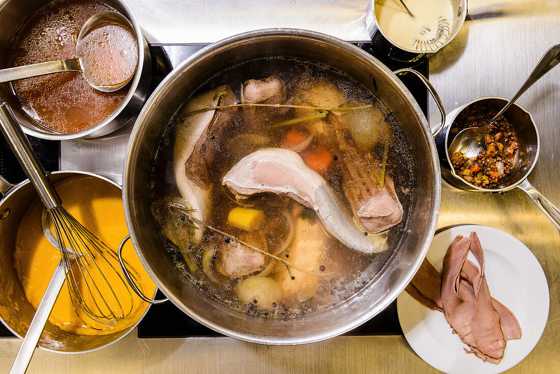 Beef broth with meat and vegetables in a saucepan