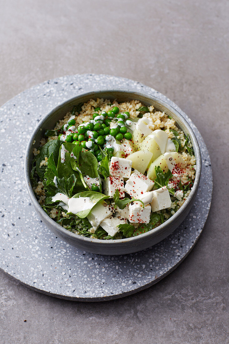 Green bulgur bowl with kohlrabi and feta cheese