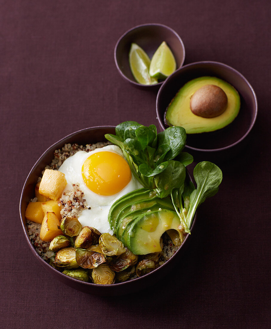 Quinoa bowl with roasted Brussels sprouts, turnips and fried egg