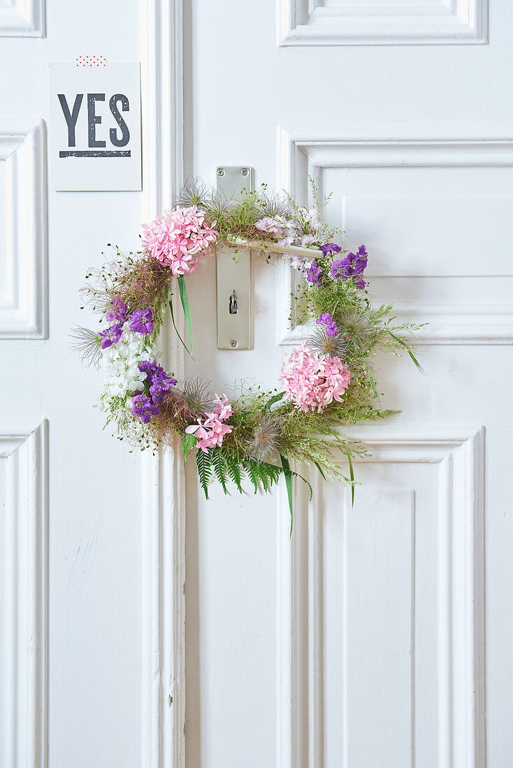 Door wreath made of flowers and seed pods