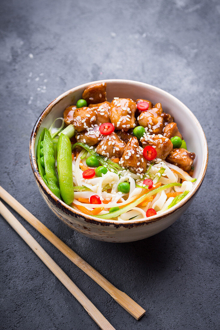 Asian style noodles with teriyaki chicken, vegetables and green peas pods