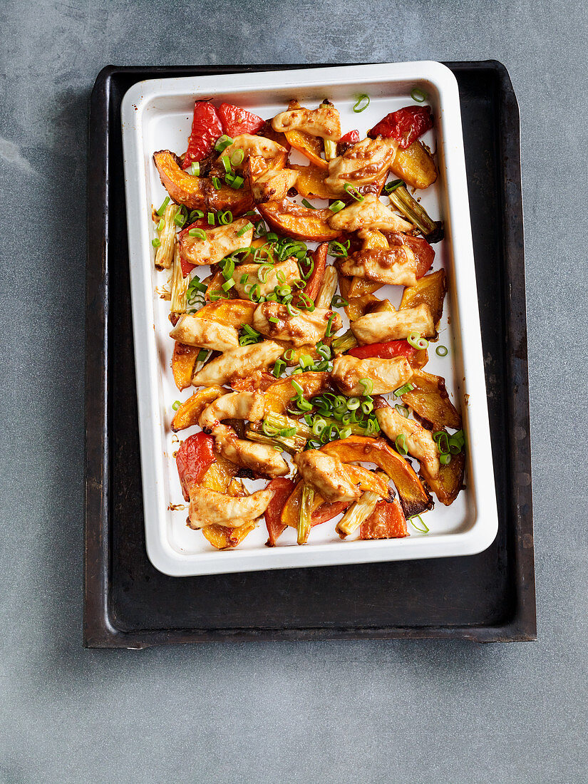 Chilli and peanut chicken on a baking tray