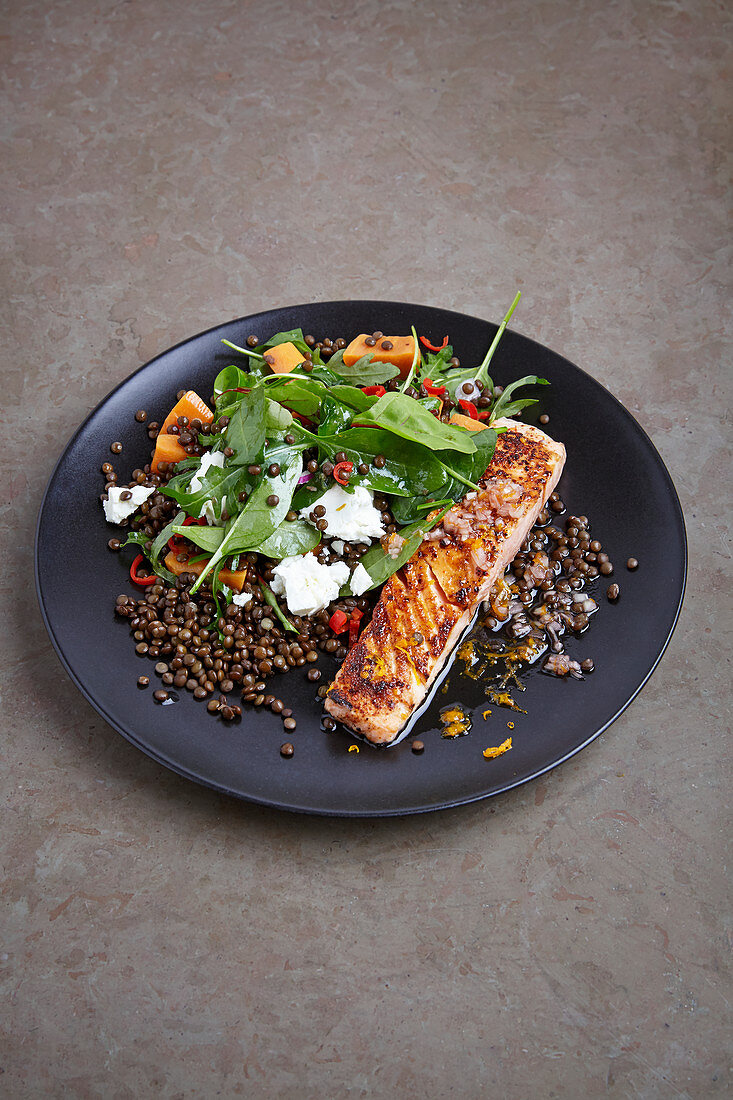 Salmon on lentils with spinach salad