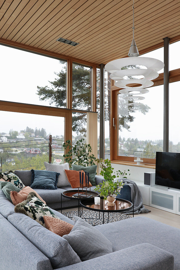 Grey sofa set in living room with glass walls