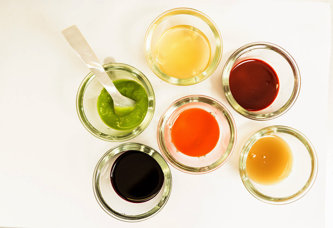 Various spices and sauces in glasses (top view)