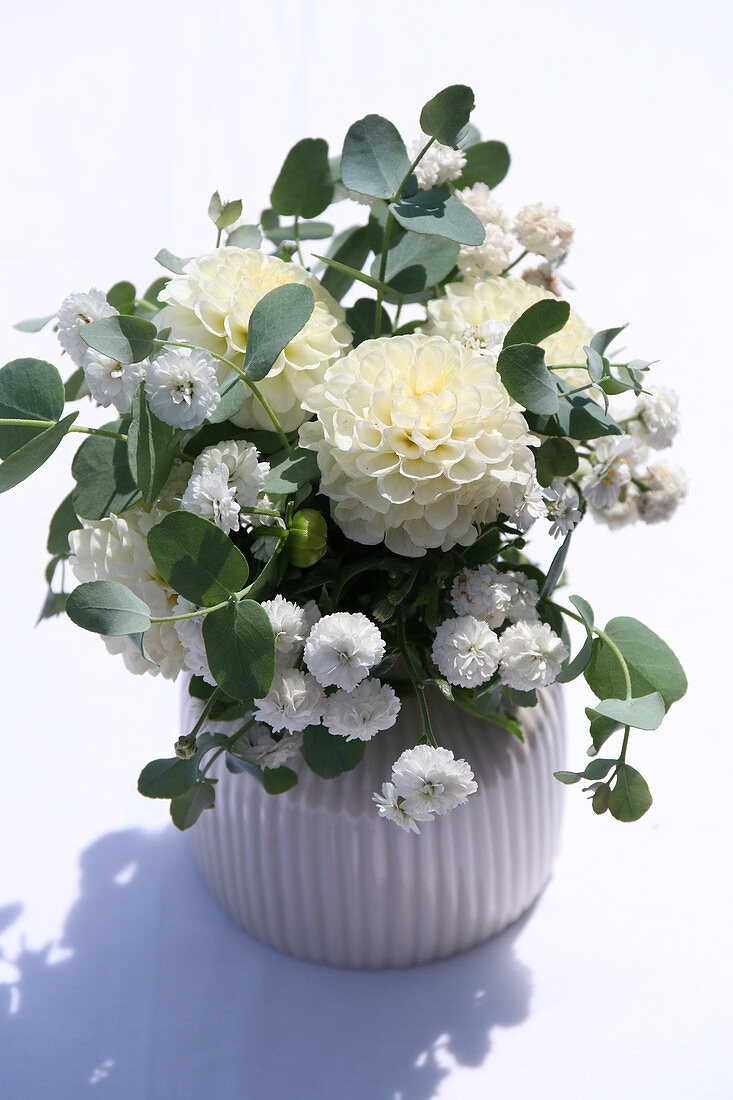White arrangement with dahlias and eucalyptus