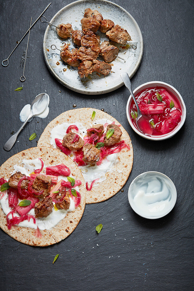 Russian shish kebab in tortillas with rhubarb sauce