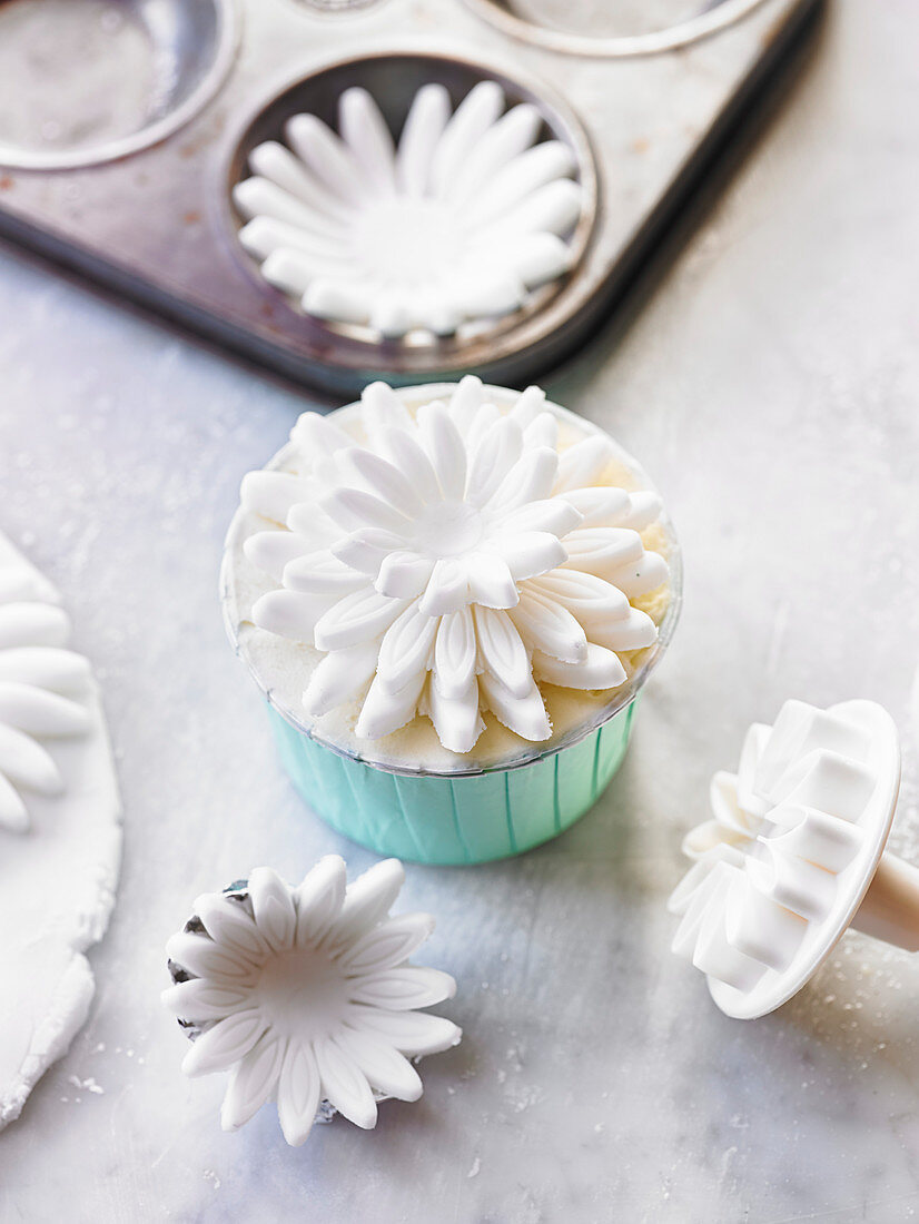 A cupcake with a fondant flower