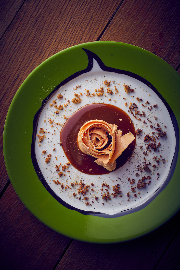 Goose liver on a sauce circle with breadcrumbs