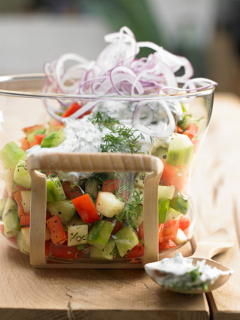 Summer salad with cucumber, peppers, apple and quark dressing