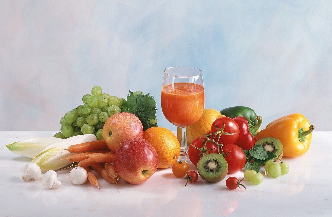 A glass of multi-vitamin juice and fresh fruit & vegetables