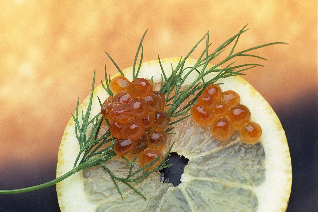 Keta caviare (salmon caviare) with dill on slice of lemon