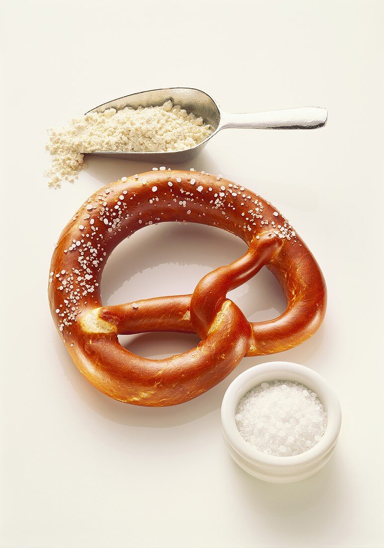 Salt pretzels, small bowl of salt, scoop of flour