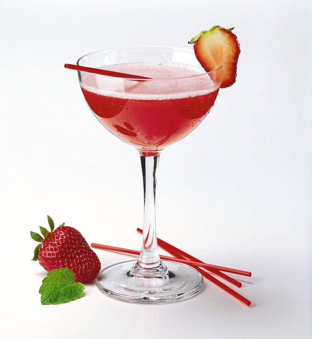 Strawberry Margarita in cocktail glass with strawberry & straw