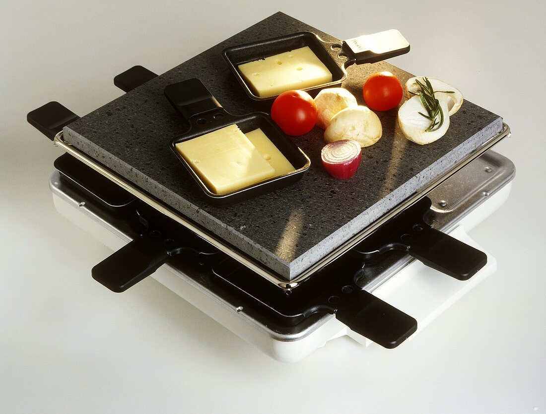 Raclette with vegetables and cheese slices as ingredients