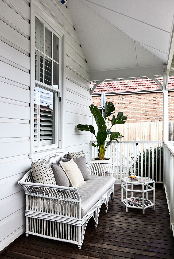 White rattan bench on American-style veranda