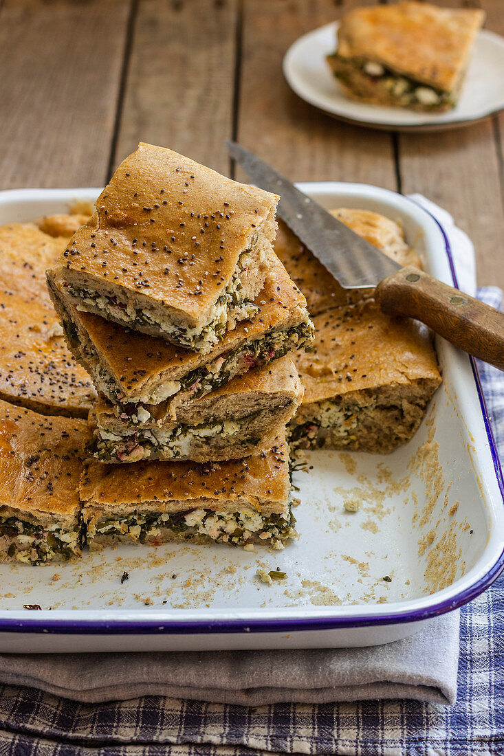 Borek cake with beetroot leaves and feta cheese, blach sesame seeds
