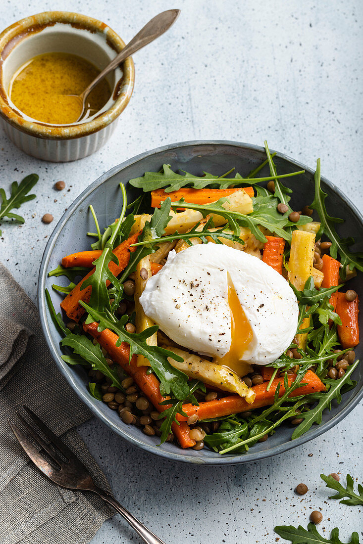 Roasted vegetables salad with lentils - roasted carrots, parsnip and celeriac, rocket, lentils and poached egg