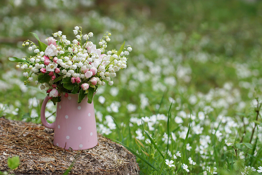 Bouquet of lilies of the valley and apple blossoms