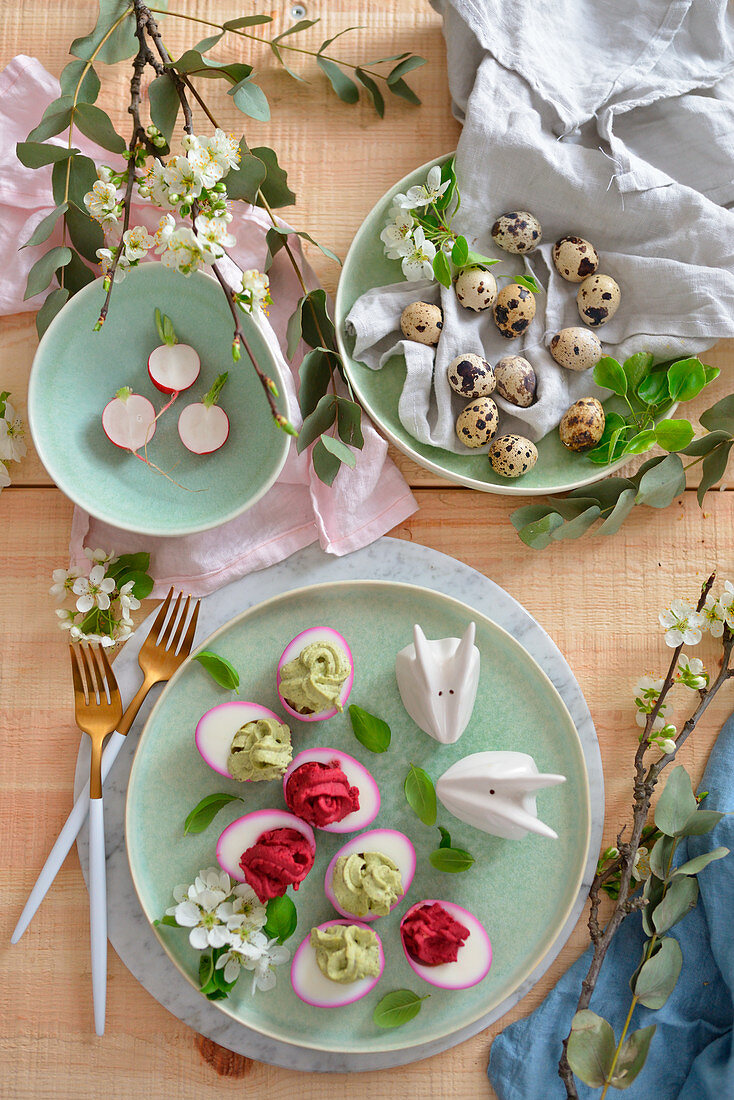 Stuffed Easter eggs on a wooden table flowers bunnies