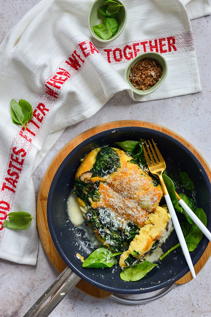 omelette with spinach in a pan