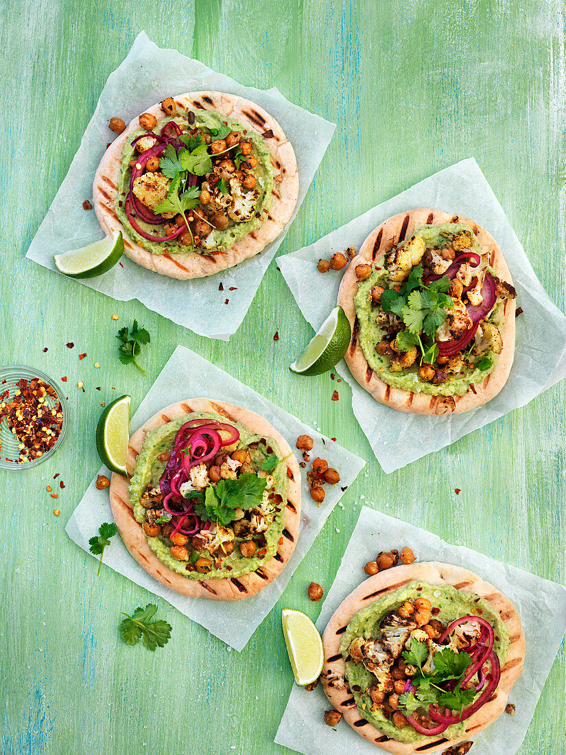 Grilled bread with green hummus, roasted chickpeas, chili flakes, lime, corinander, roasted culiflower and pickled onion