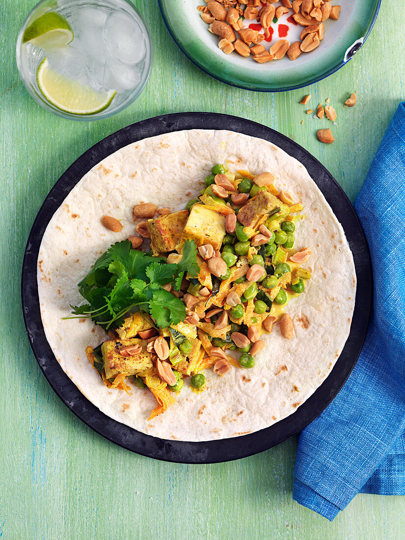 Vegan tortilla with tofu, green peas, coriander, peanuts and leek