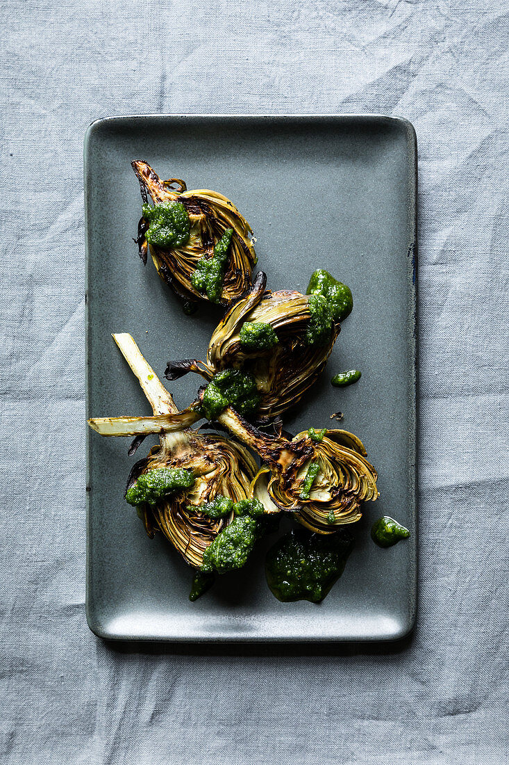 Grilled young artichokes with a parsley and mint pesto