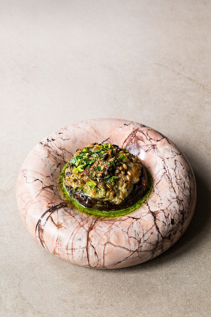 A portobello mushroom filled with grains, celery and cheese