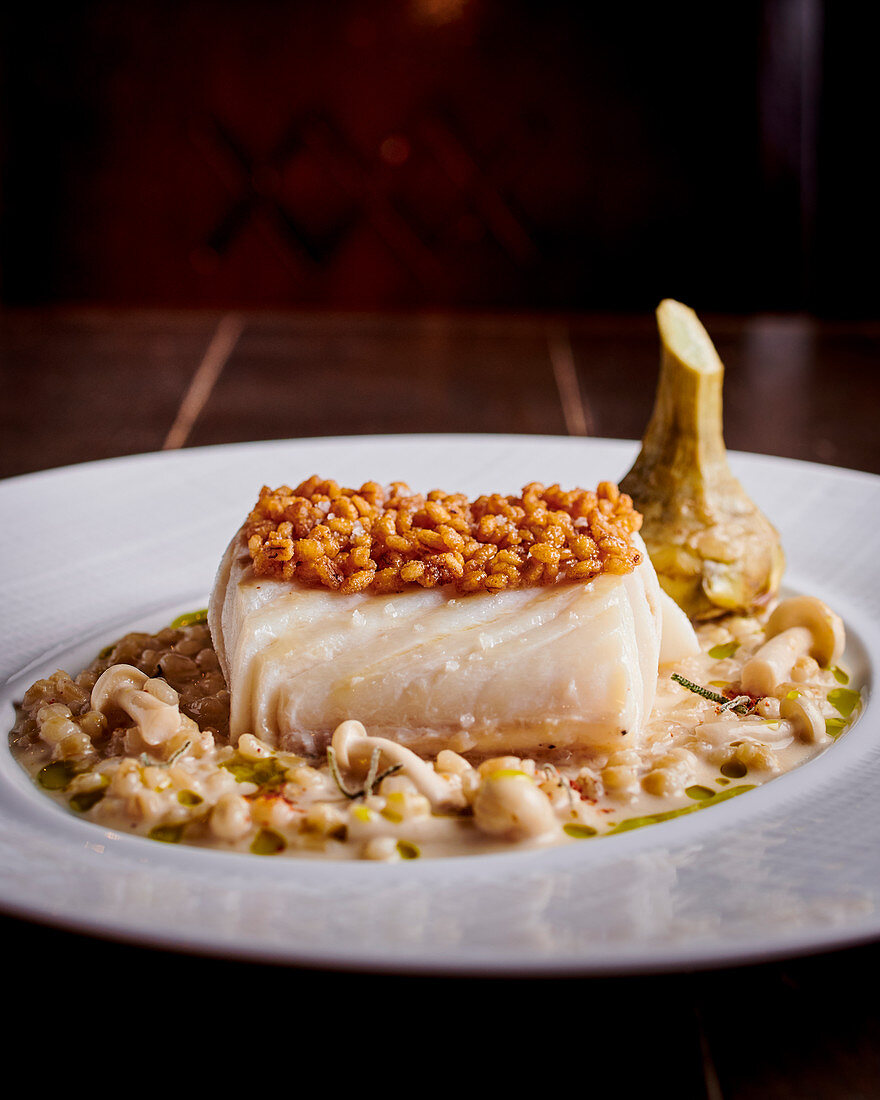 Cod in a beer sauce with spelt and mushrooms
