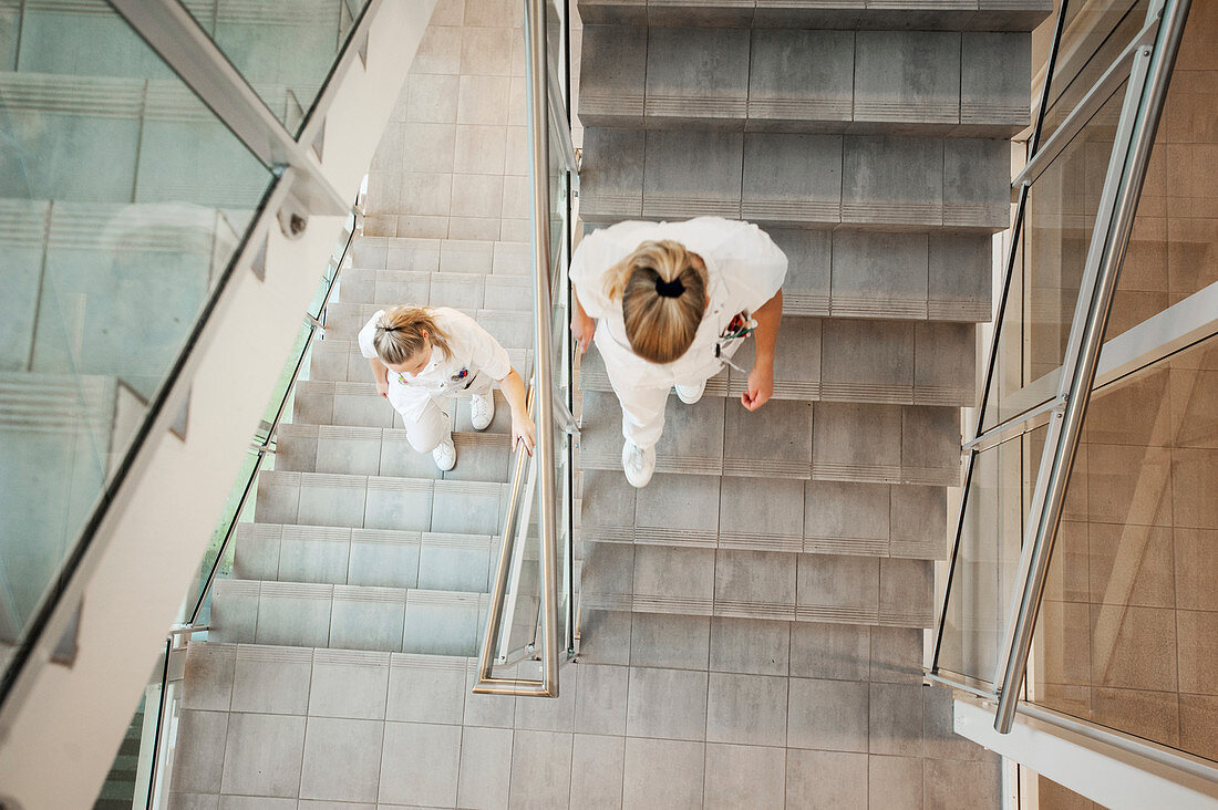 Nurses walking down the stairwell of a hospital