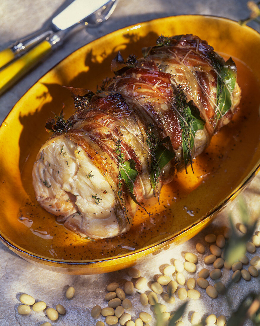 Monk fish wrapped in ham with bay leaves