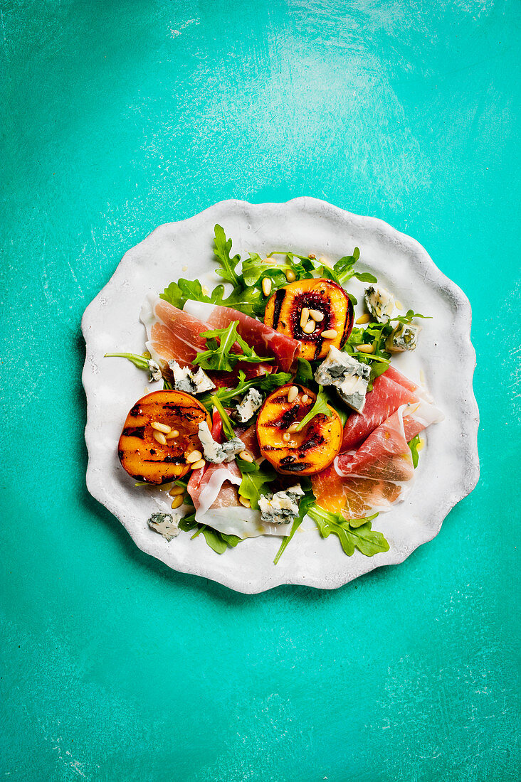 Grilled peach and gorgonzola salad with raw ham