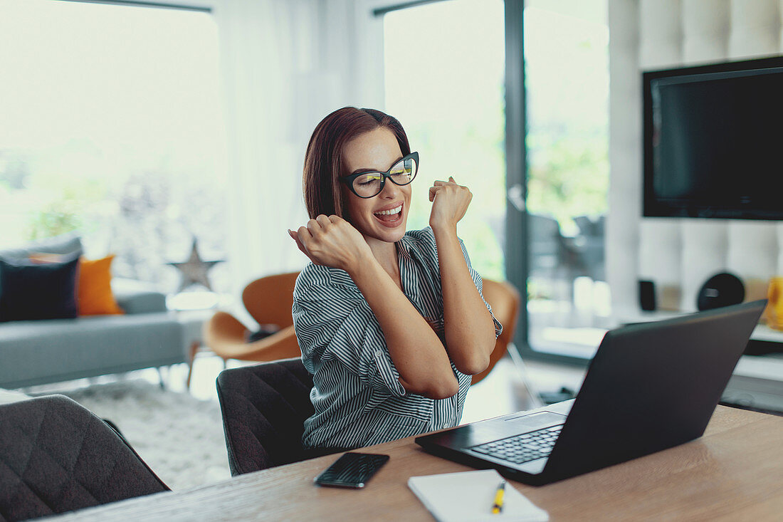 Happy woman using laptop