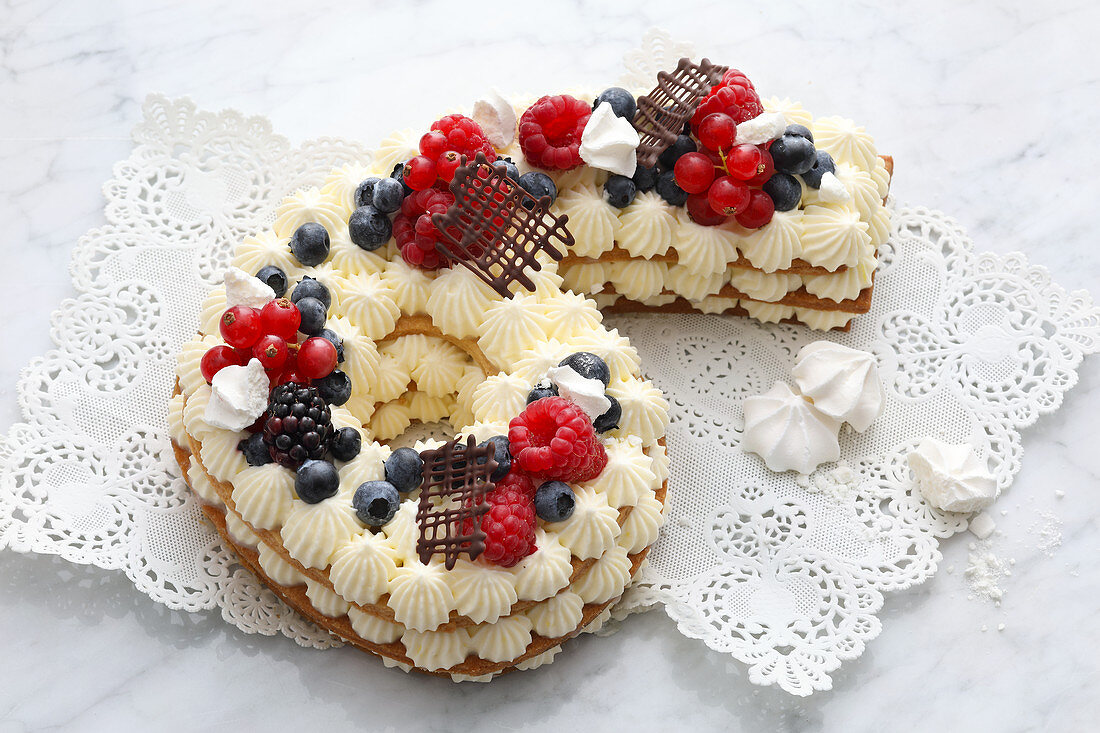 A number cake with cream and fresh berries