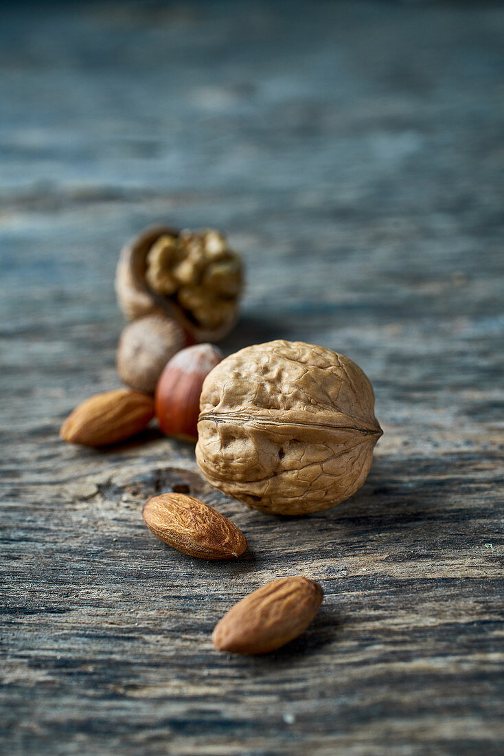 Walnuts, hazelnuts and almonds on a wooden surface