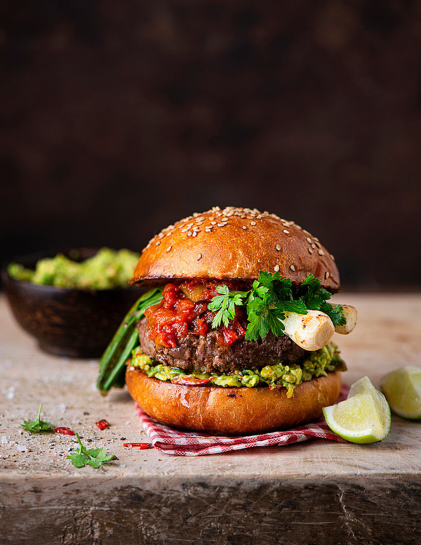 Burger with avocado and spring onions