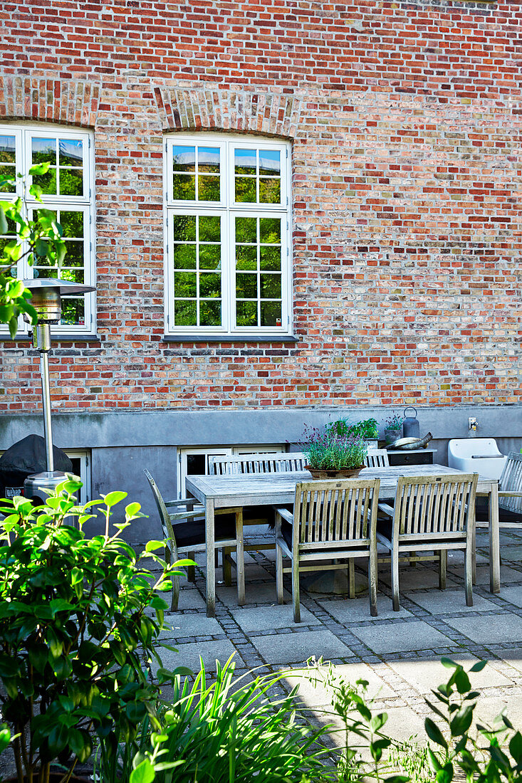 Seating area on paved terrace adjoining house