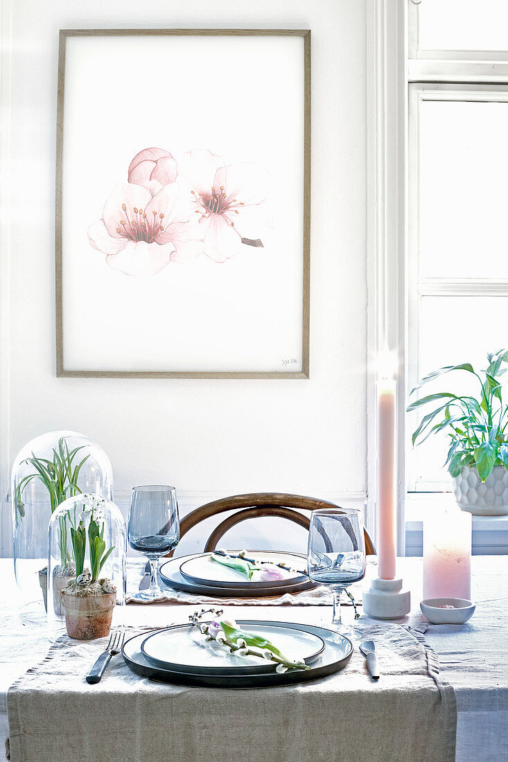 Picture of flowers above set table with spring decorations in pastel shades