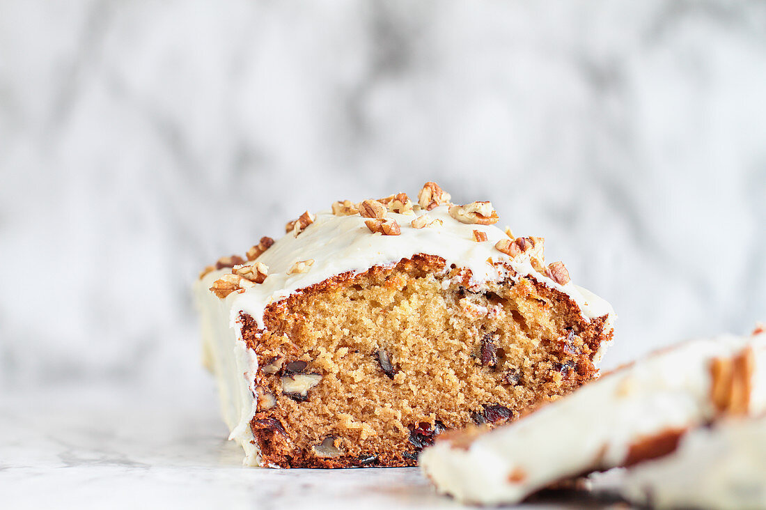 Fresh cranberry bread with chopped pecans and white chocolate and candy frosting