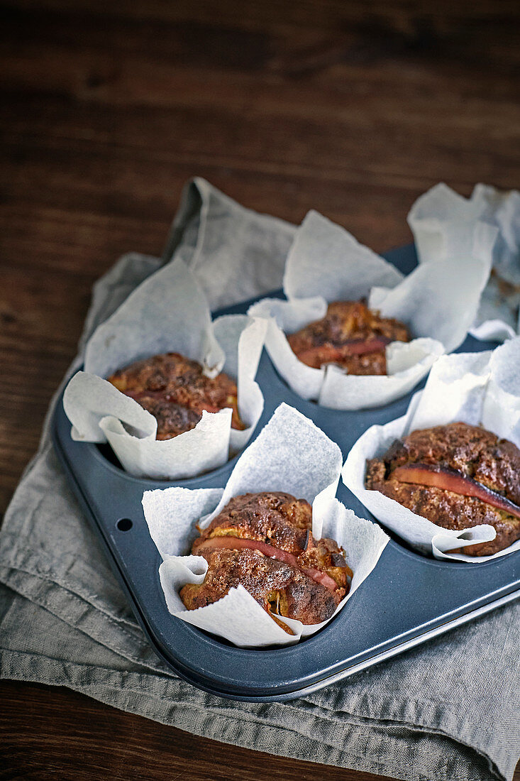 Apple and banana muffins in a baking pan