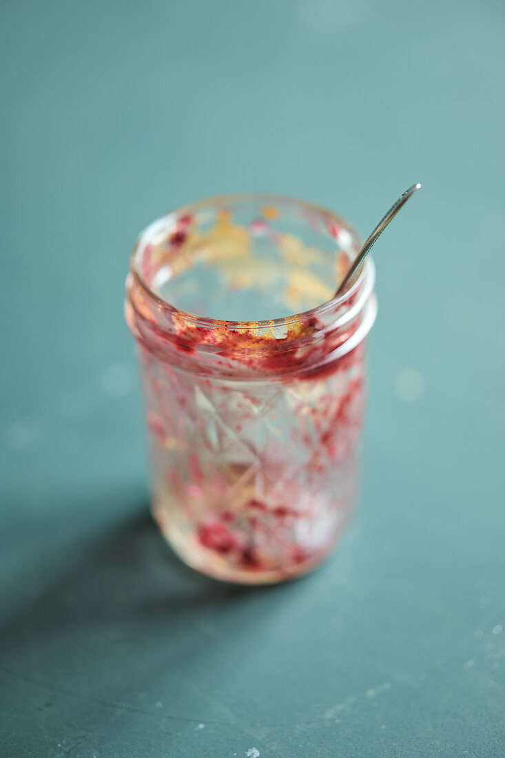 Empty glass jar with cake scraps