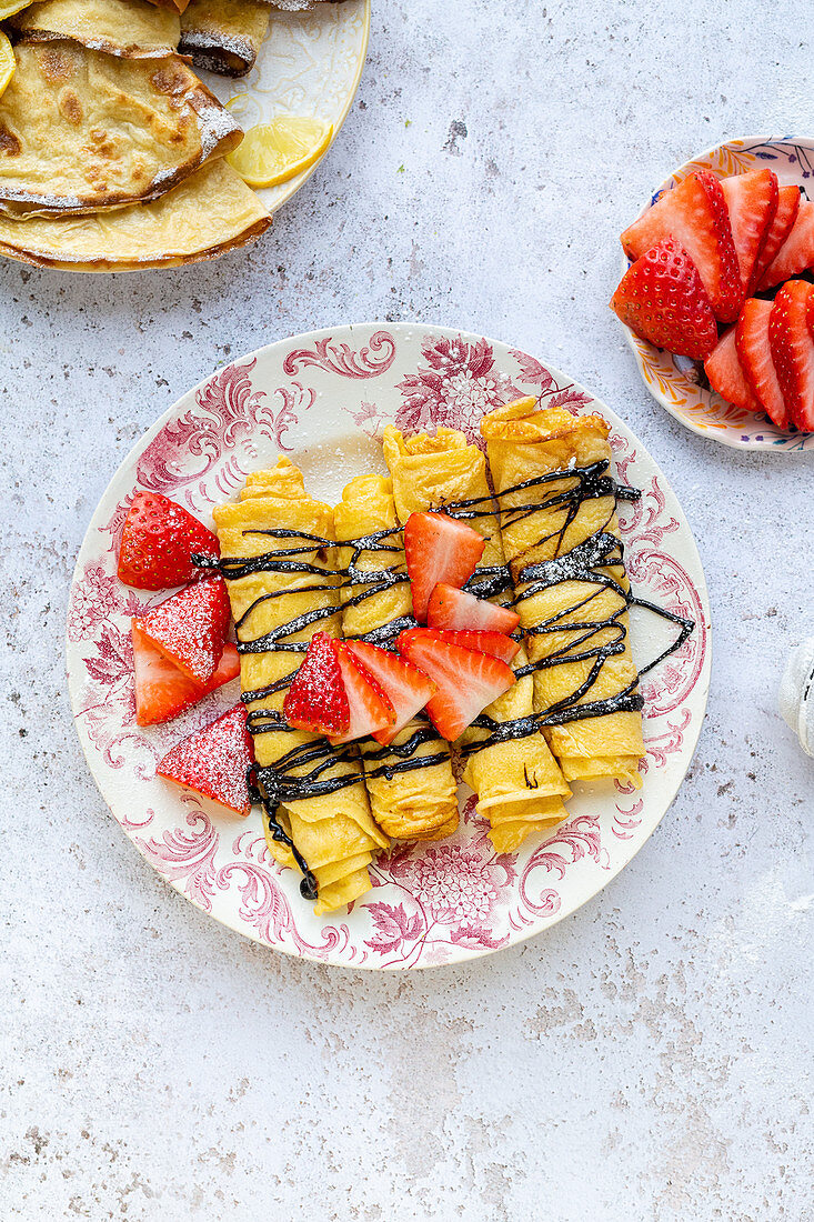 Pancakes with chocolate sauce and strawberries