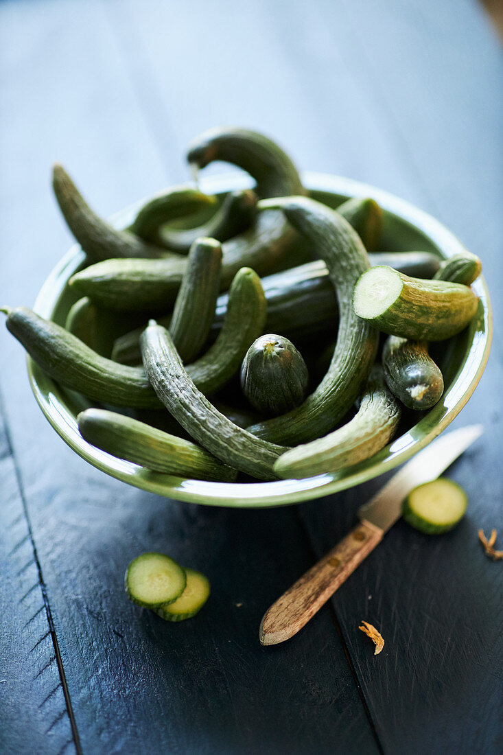 Fresh small snake cucumbers in a bowl