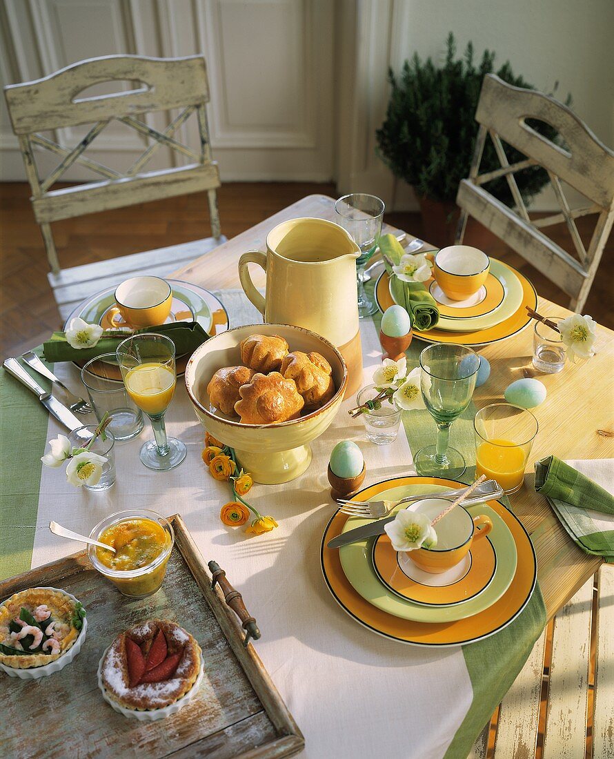 Breakfast table with Easter eggs, breads and pastries etc